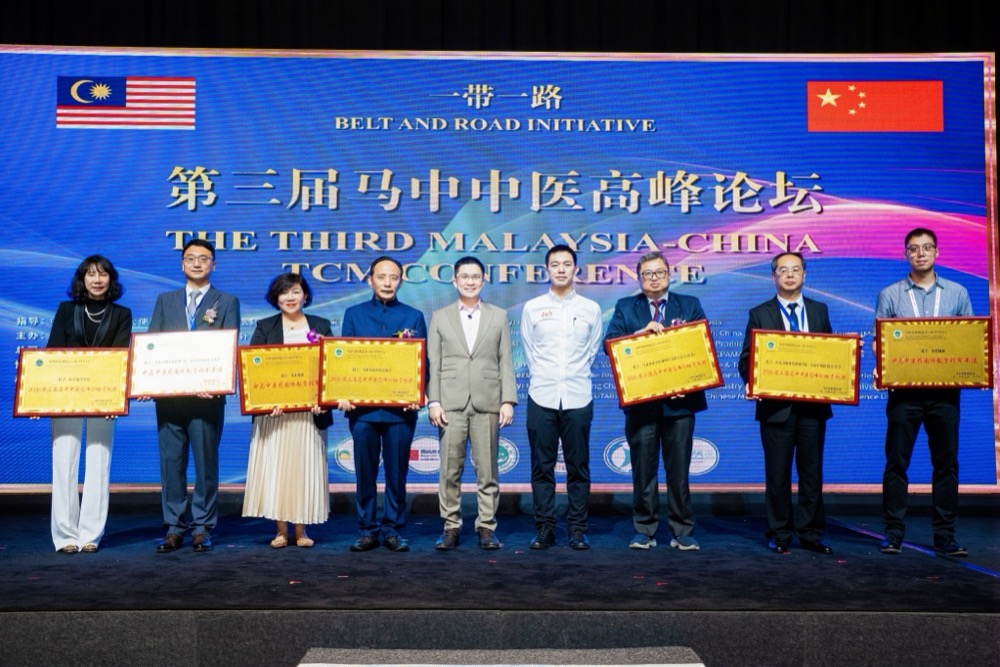 Recipients holding appointment certificates on stage